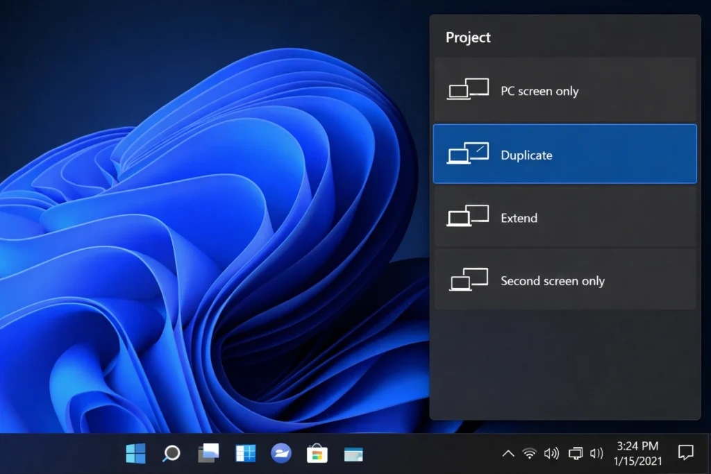 Windows 11 display projection panel showing Duplicate option selected to test Dell laptop screen on external monitor